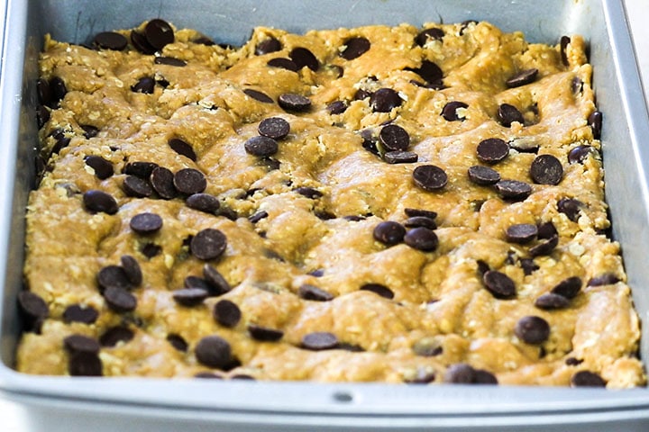 The dough in the pan with extra sprinkled chocolate chips