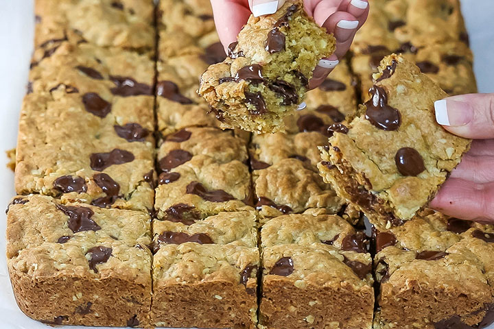 The sliced cookie bars being broken in half 