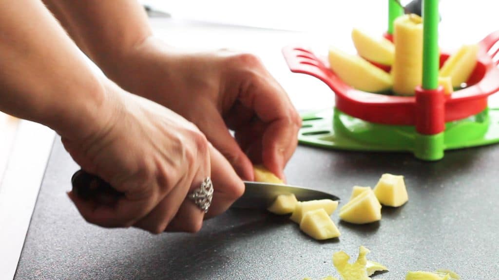 Apples being cut on a cutting board