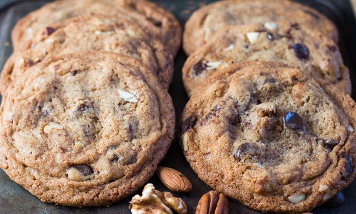 Nutty Chocolate Chip Cookies in two rows of three with mixed nuts 