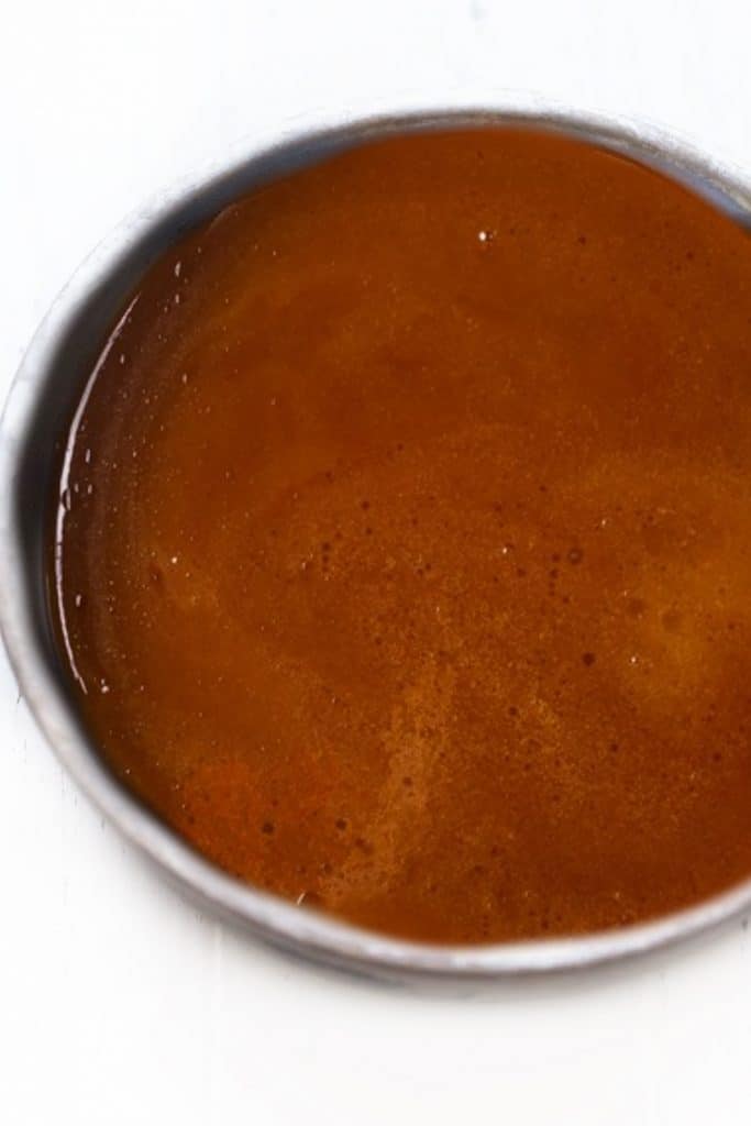 the caramel sauce in the cake pan