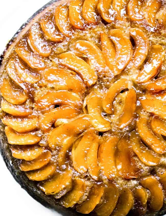 A close up of a warm apple cake topped with baked apples