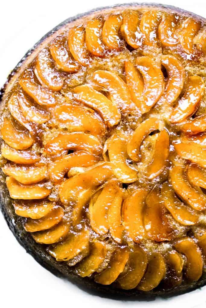 A close up of a warm apple cake topped with baked apples