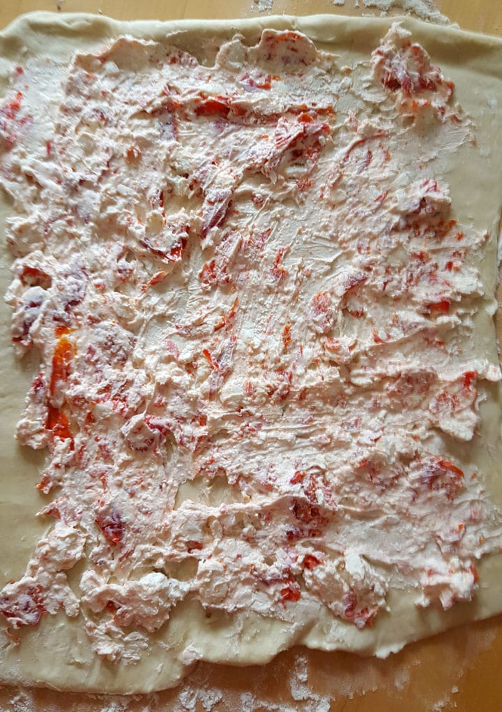 cream cheese and pepper mixture spread over pastry