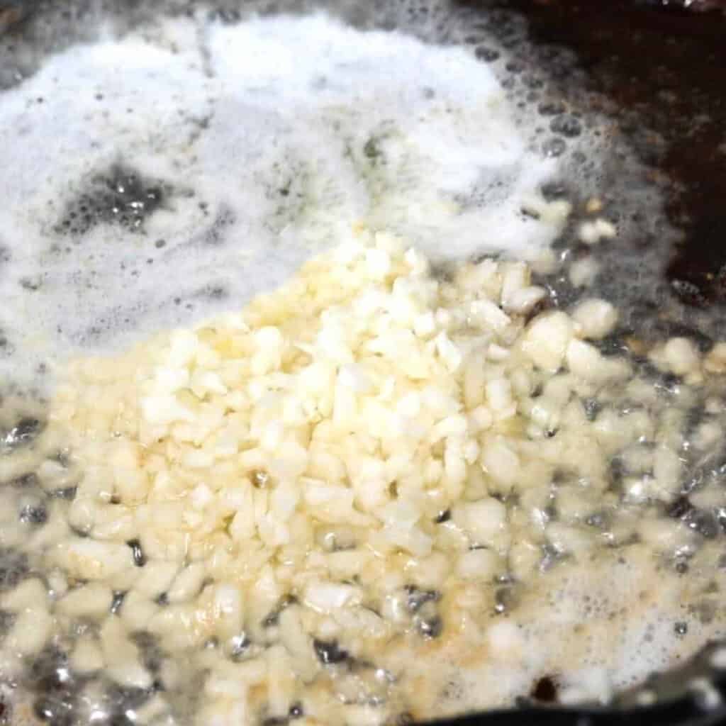 garlic and shallots cooking in a pan
