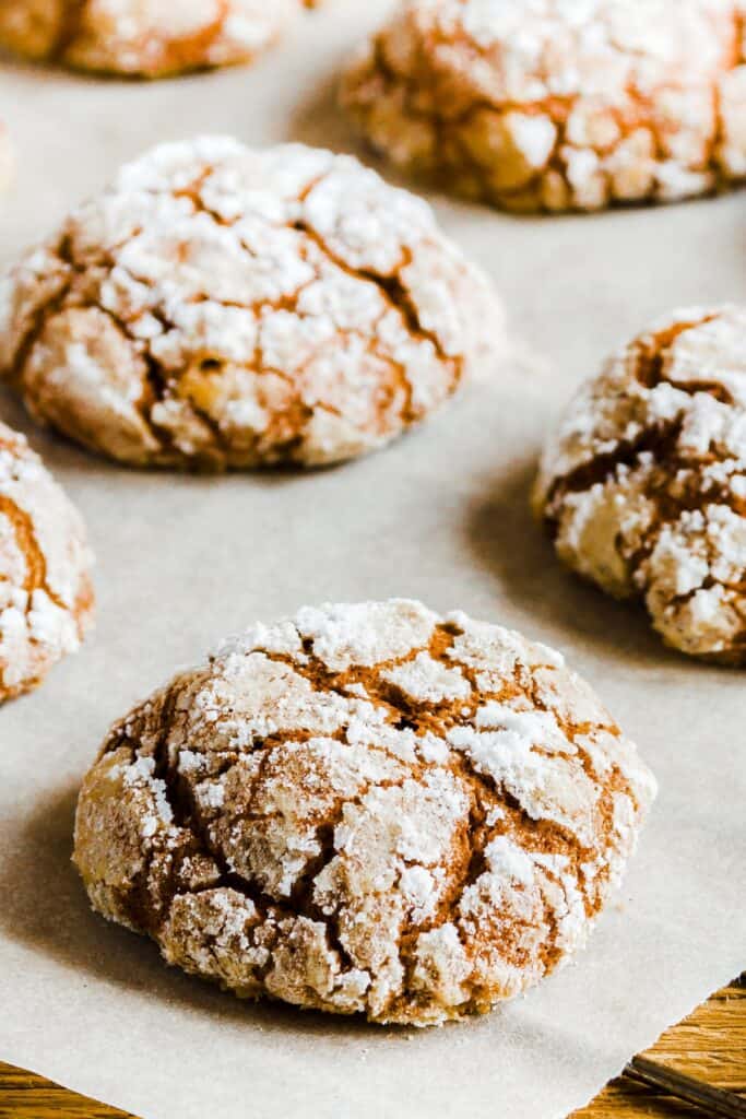 Chocolate crinkle cookies on baking paper with copy space - homemade winter chocolate Christmas pastry