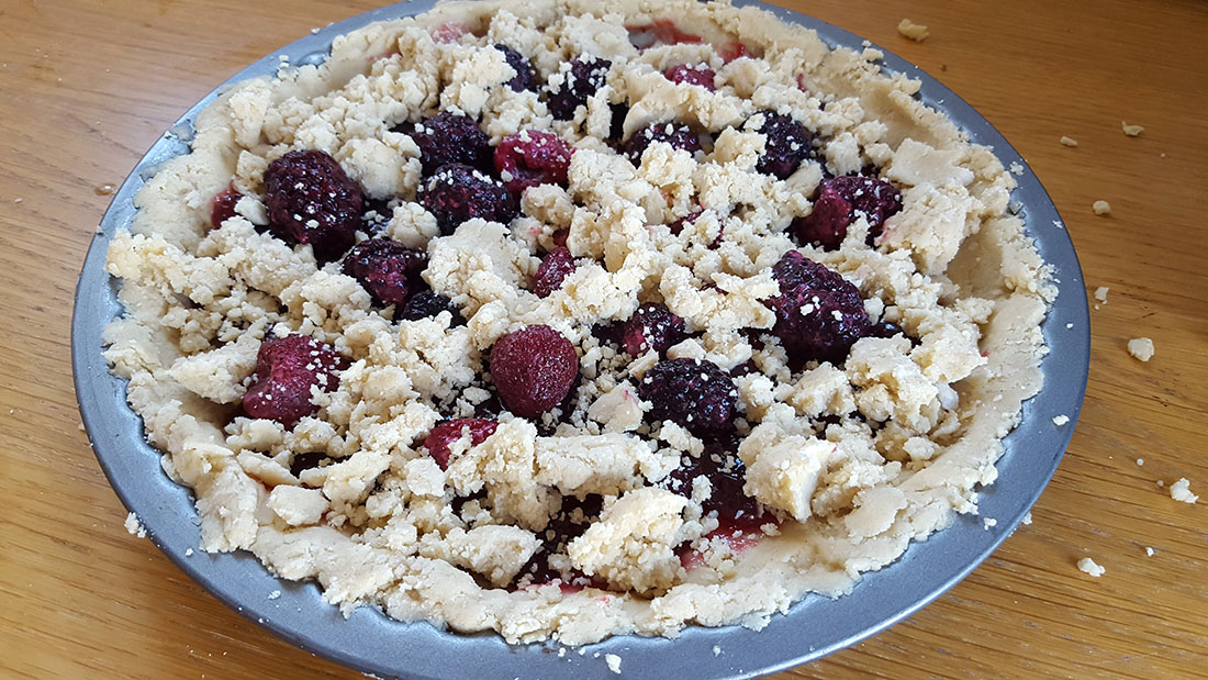 Raspberry and White Chocolate Shortbread Tart ready to bake in the oven