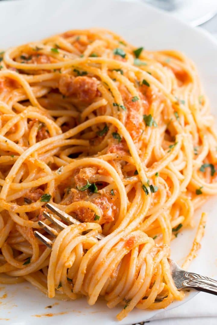 Spaghetti with Skinny Tomato Cream Sauce with a fork twirled into it