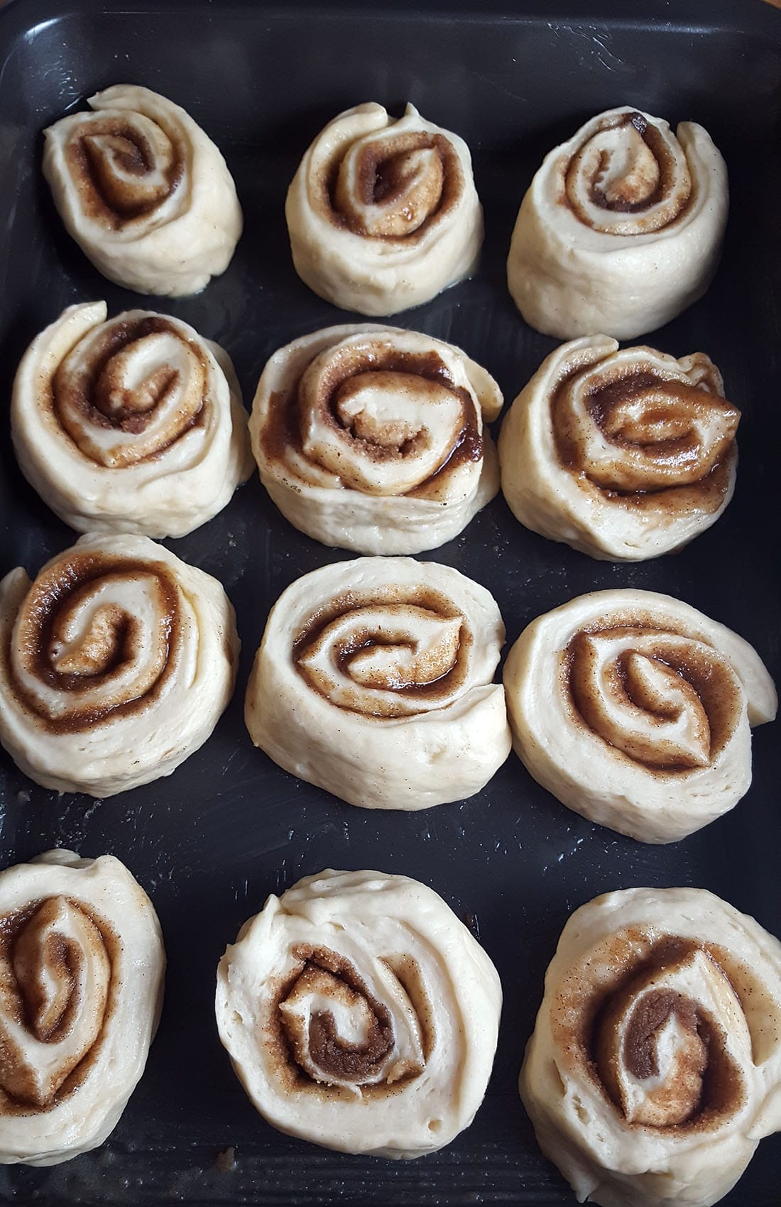 cut buns on a buttered pan before a second rise.