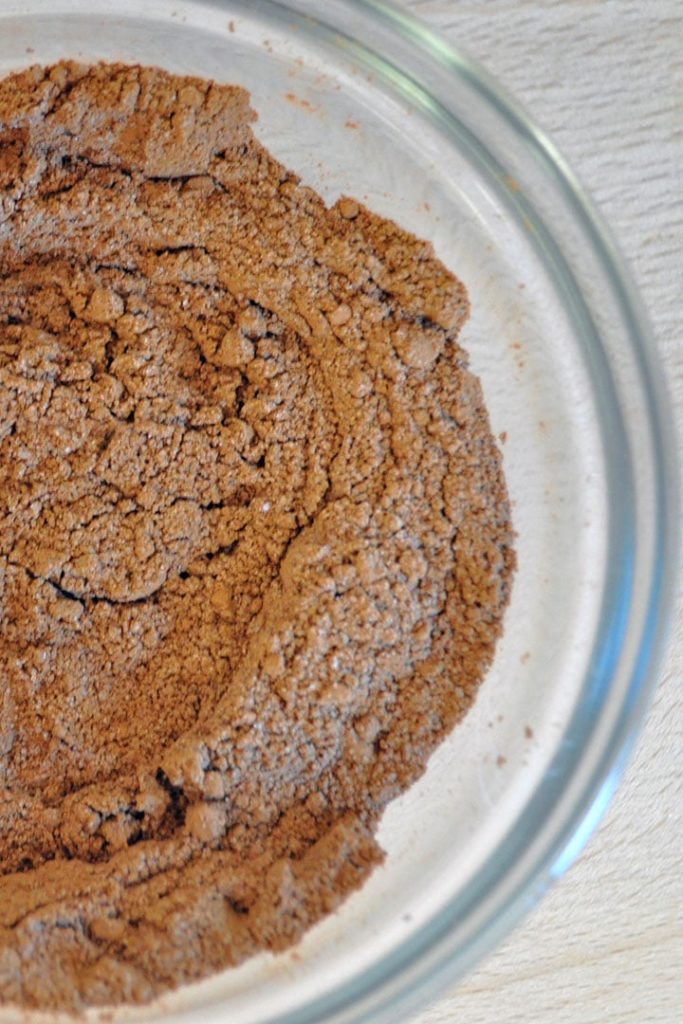 A bowl with flour, cocoa powder, sugar, salt,and baking powder mixed together