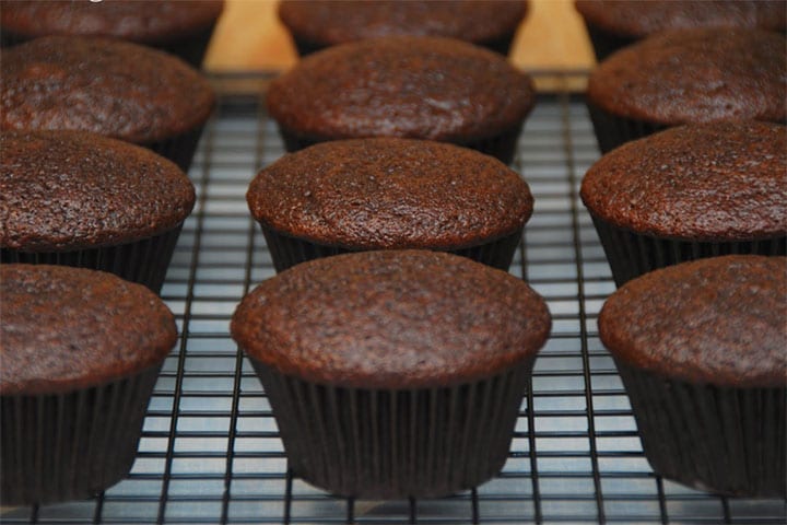 The devils food cupcakes cooling on a cooling rack