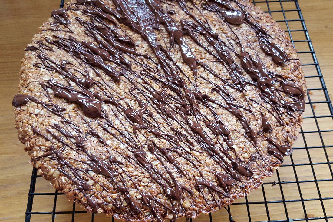 Peanut Butter Oat Bars out of the oven and drizzled with chocolate.