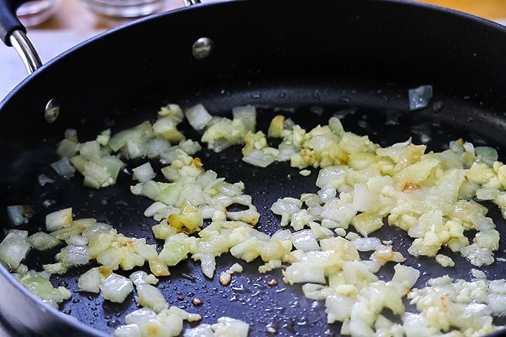 Onions and garlic cooking in a pan