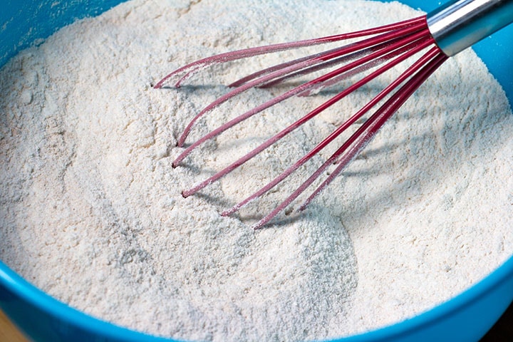 a bowl with the dry ingredients being mixed together