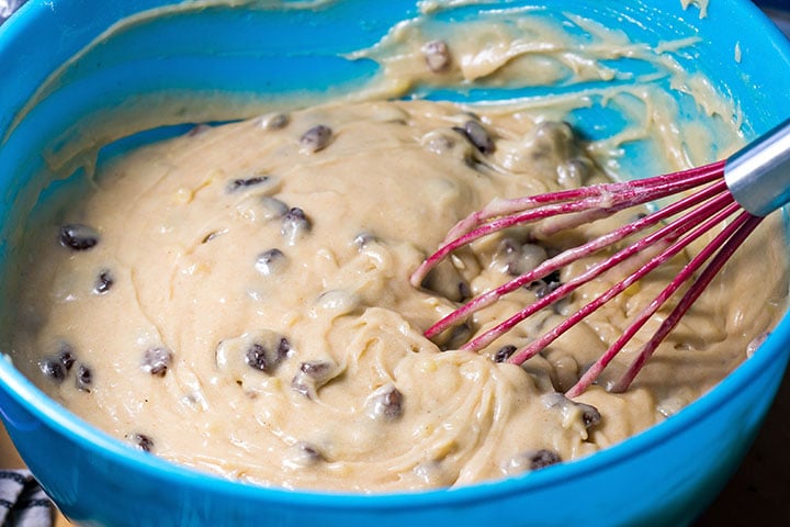 the raisins being mixed into the batter