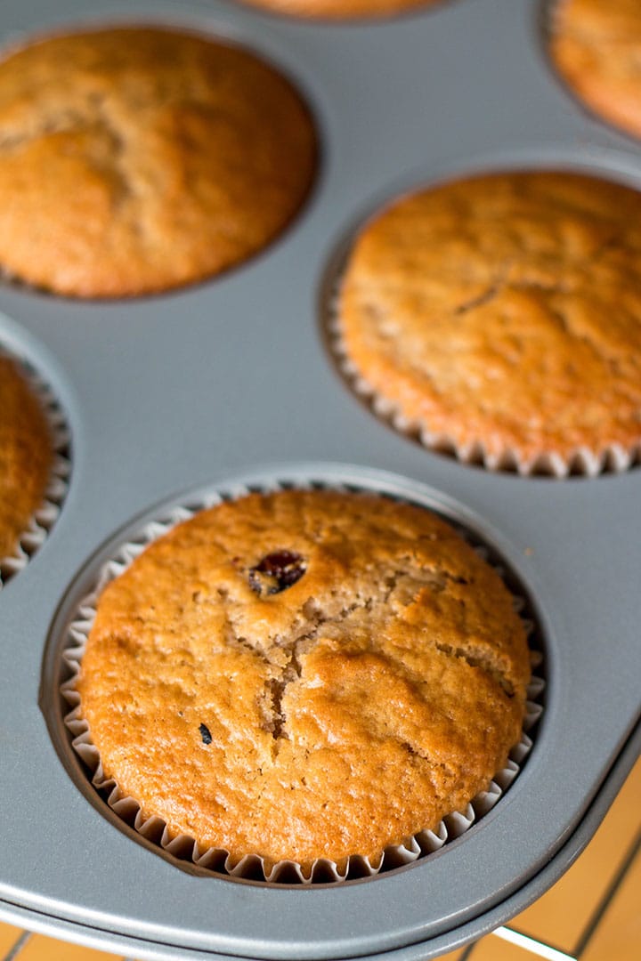 The golden brown muffins fresh out of the oven still in the pan