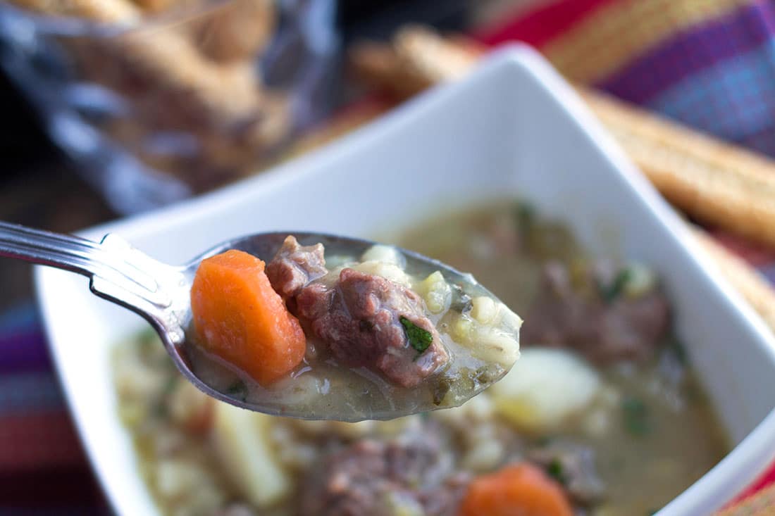 Classic Irish Stew in a square bowl with a spoonful being lifted