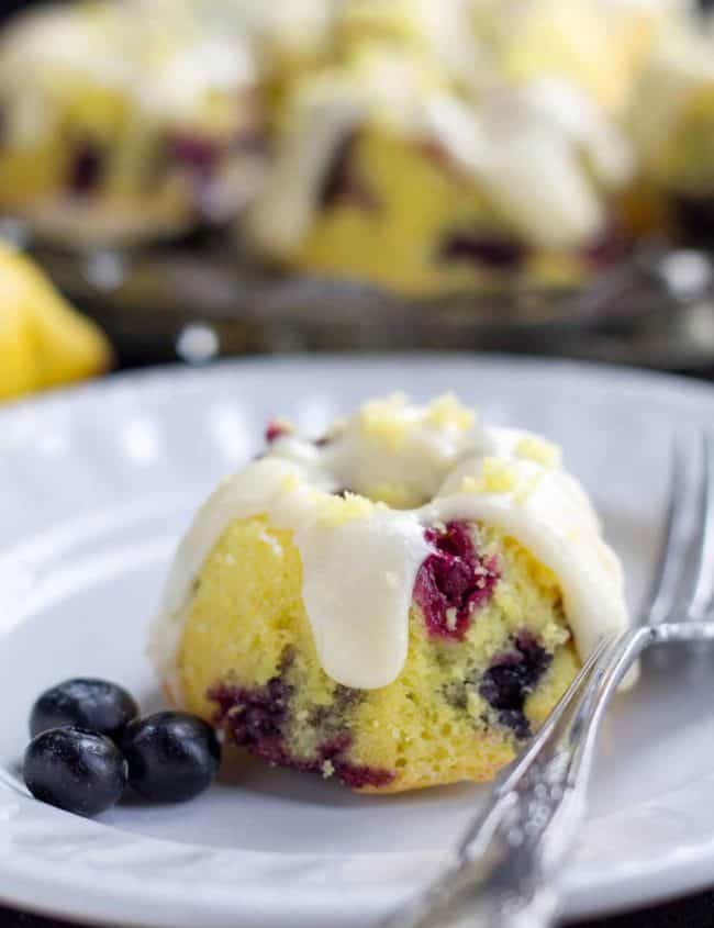 a mini Easy One Bowl Lemon Blueberry Cake with Cream Cheese Frosting on a plate with a fork