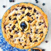 homemade blueberry tart on white wooden surface
