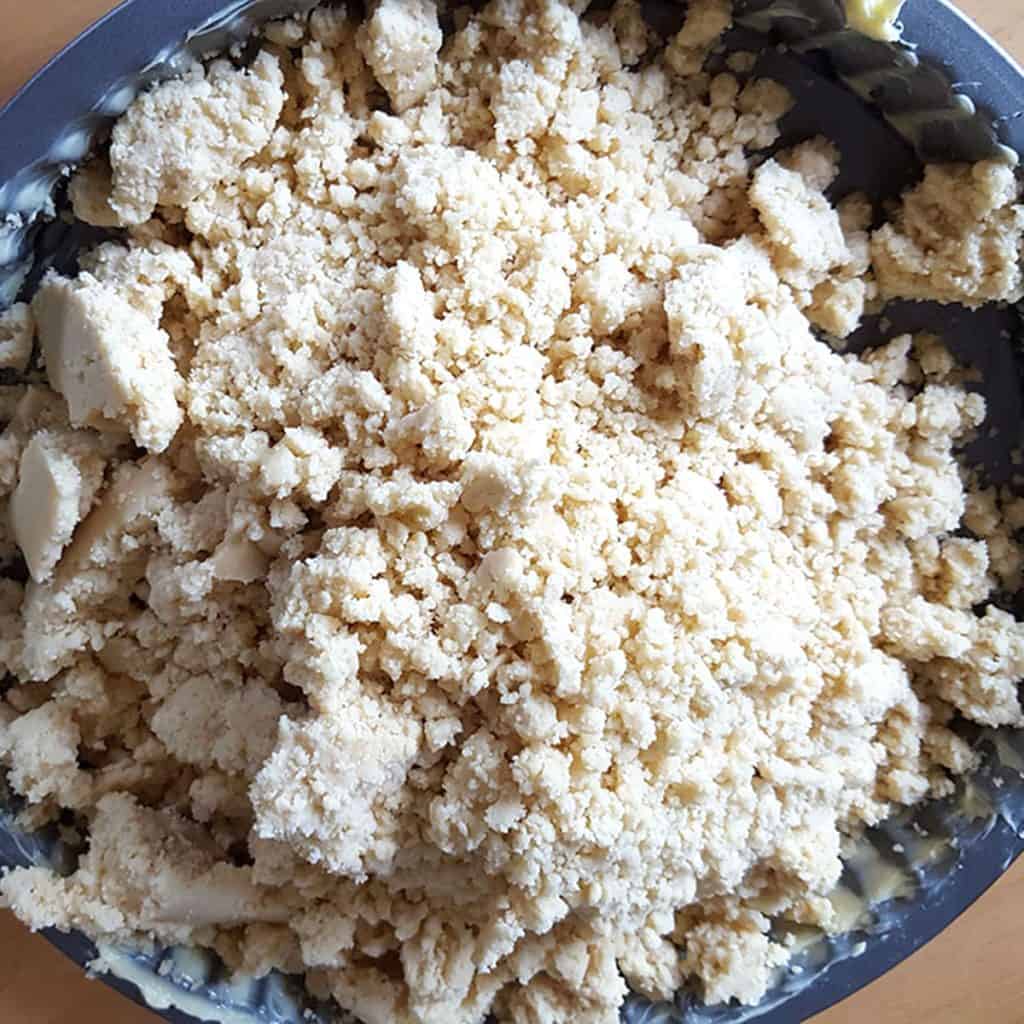 crumbled shortbread dough in a pie plate