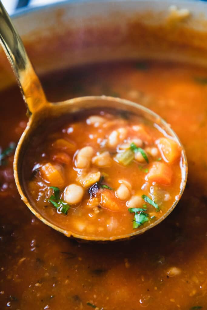 a ladle full  of pasta e fagioli soup