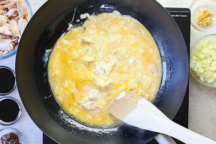 scrambled eggs cooking in a wok