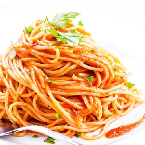 Plate of pasta with Easy Homemade Tomato Sauce and parsley sprinkled over it.