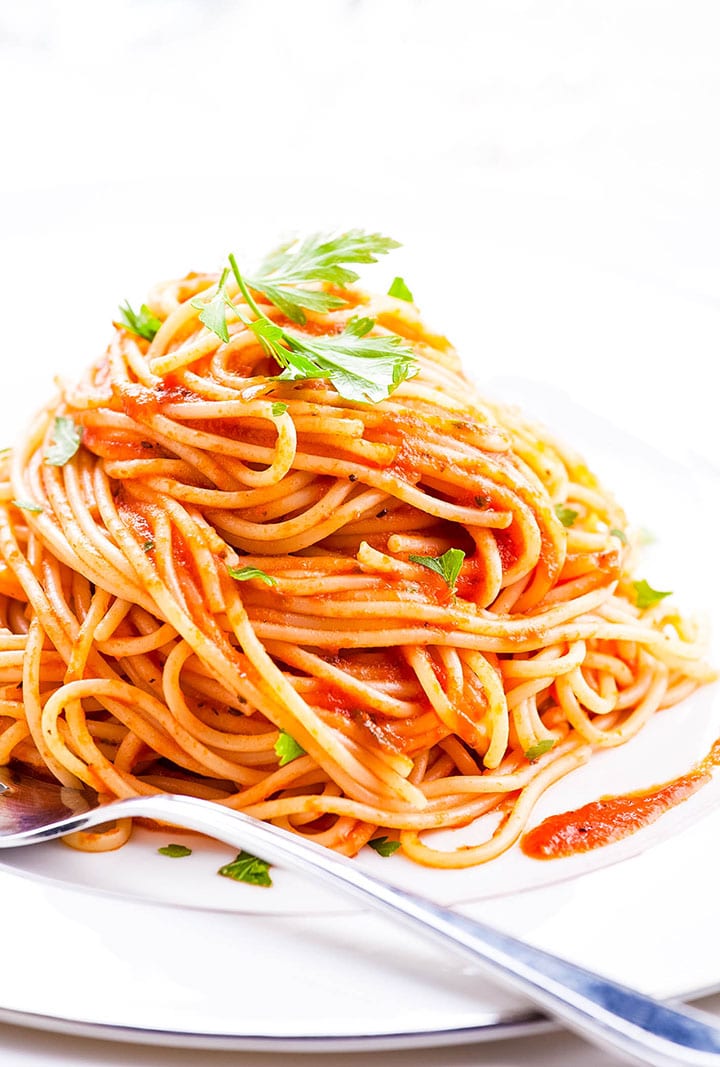 Plate of pasta with Easy Homemade Tomato Sauce and parsley sprinkled over it.