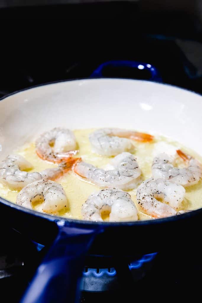 shrimp cooking in the pan with the butter and olive oil