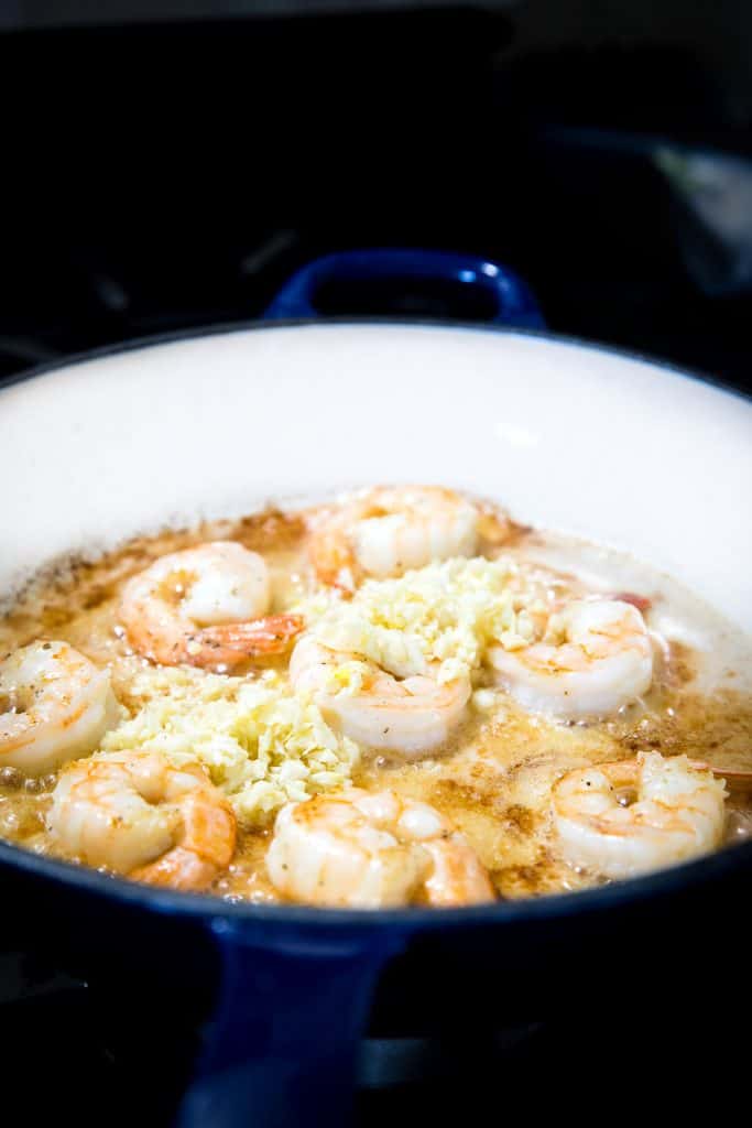 the garlic added to the pan with the shrimp