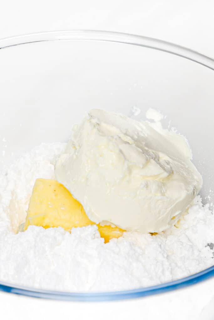 the cream cheese vanilla, butter, and powdered sugar in a glass bowl