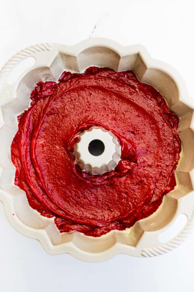 the red velvet cake batter spread into a Bundt pan