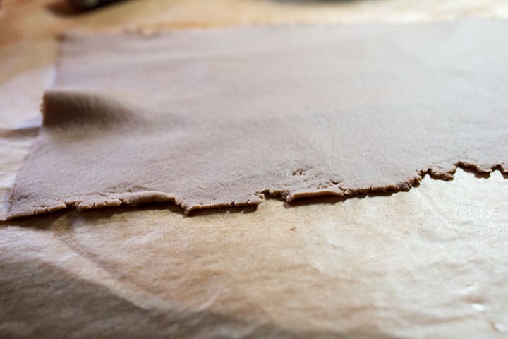 A close up of the dough rolled with the pasta maker