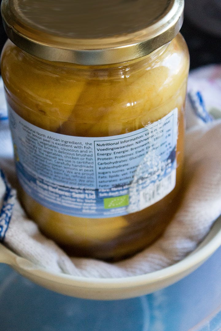 A close up a jar in a strainer lined with a cloth