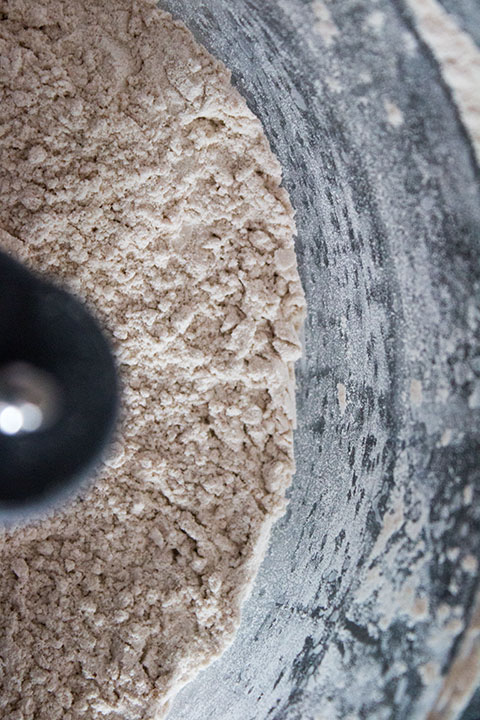 a close up of a food processor bowl with the butter cut into the dry ingredients.