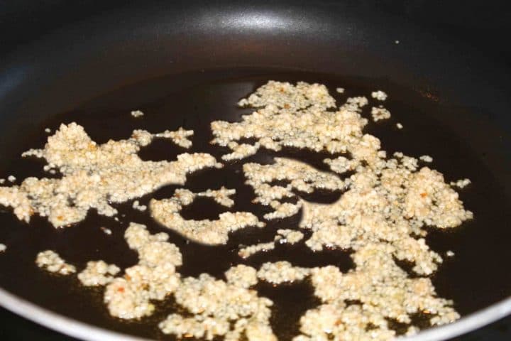 Chopped garlic sauteing in a pan