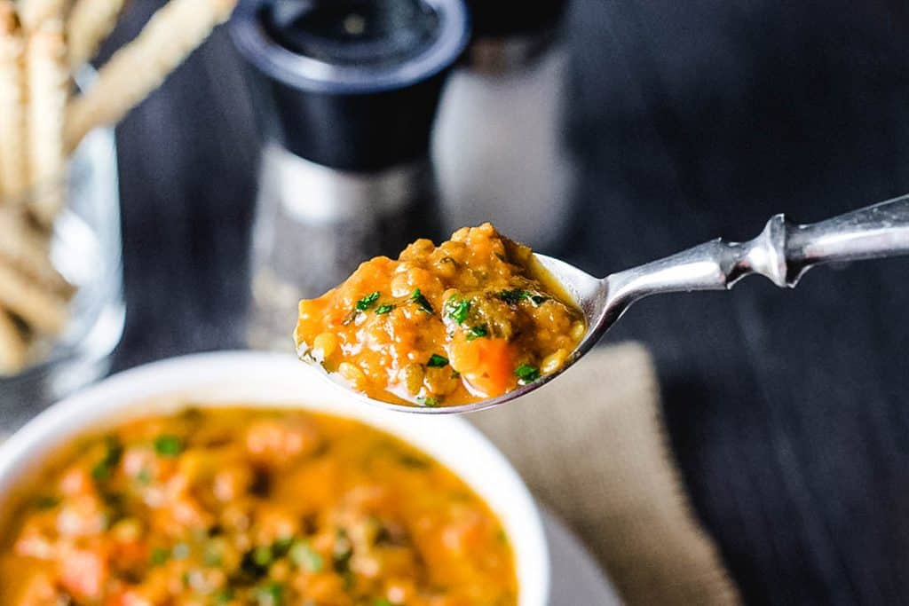 a spoonful of lentil soup ready to eat