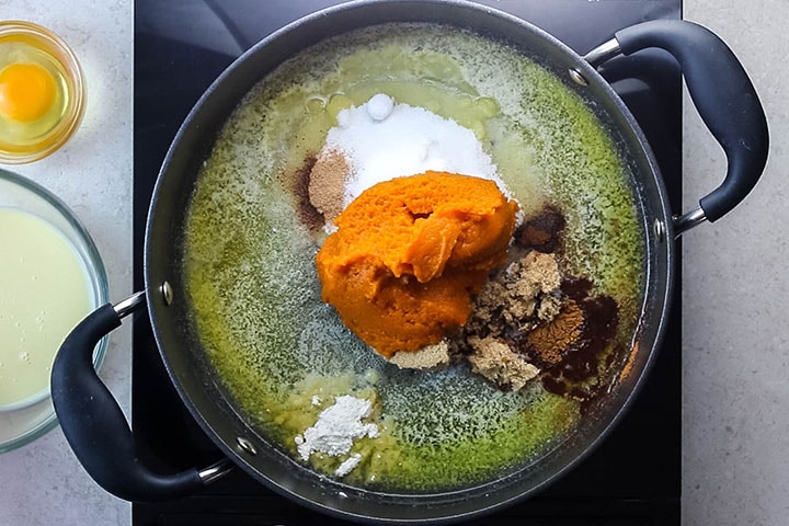 brown sugar, sugar, cinnamon, nutmeg, ground cloves and pumpkin added to the butter in the pan
