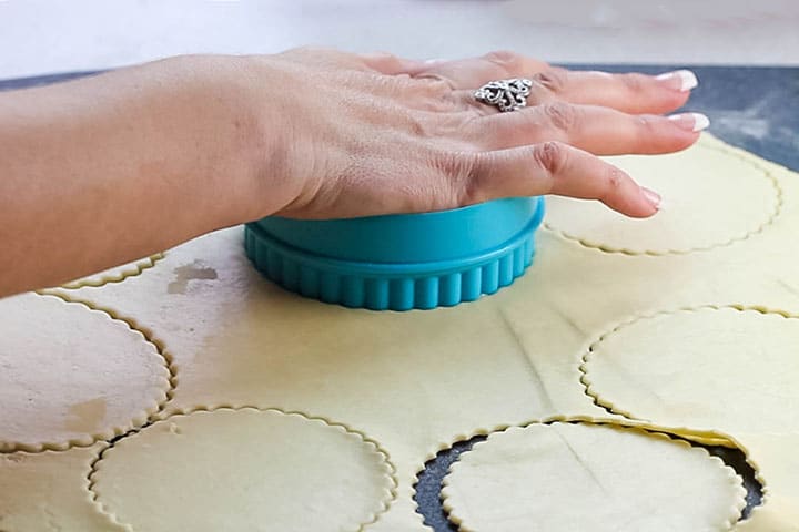 the rolled out dough with circles cut out of it.