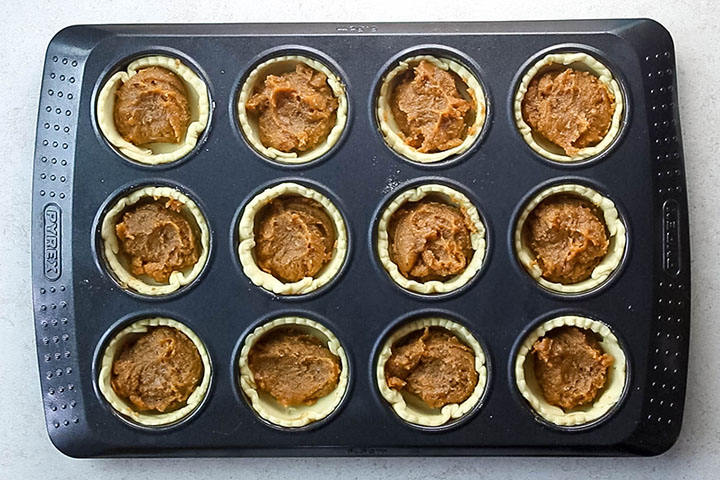 The pumpkin filling added to the tart shells