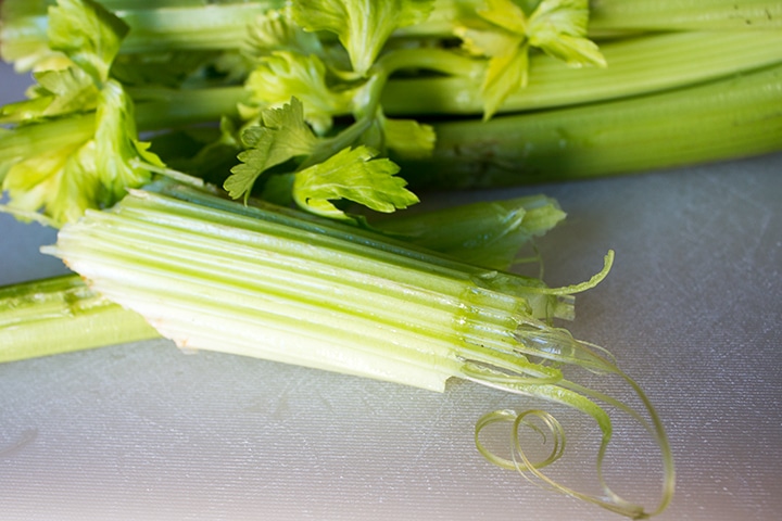 A snapped piece of celery with the strings showing