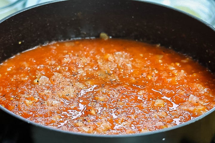The stock and tomatoes added to the pan