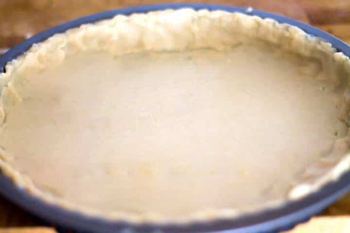A part pan with the rolled out crust pressed into the pan