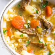 A white bowl filled with brisket soup.