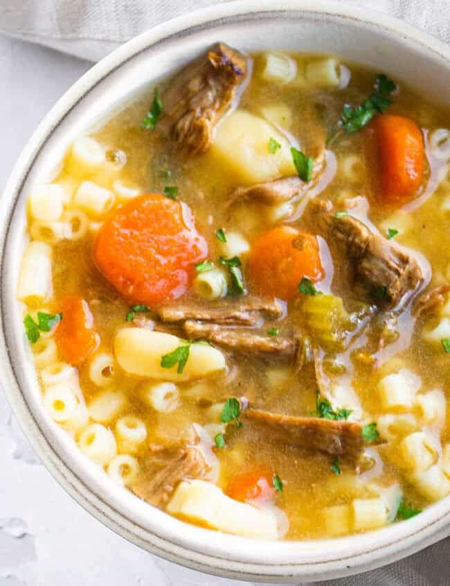 A white bowl filled with brisket soup.