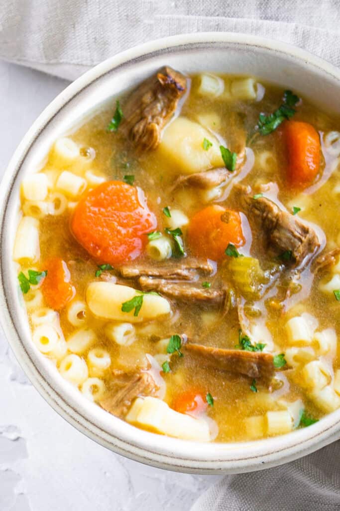 A white bowl filled with brisket soup.