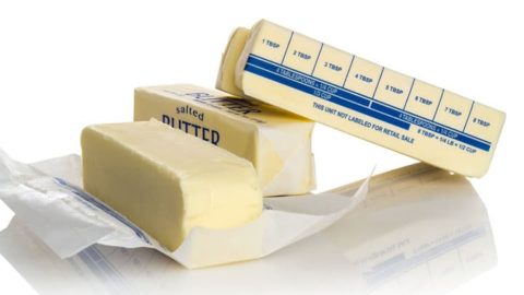 Four sticks of salted butter with one showing tablespoon markers