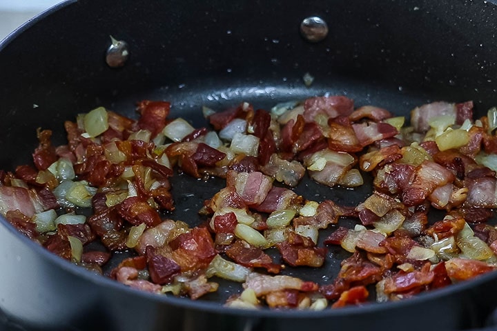 Bacon, onion and garlic cooking in a pan