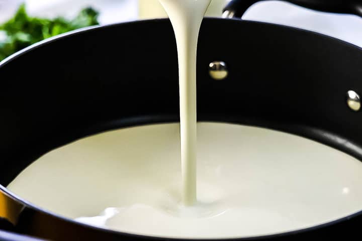 cream being poured into a pan