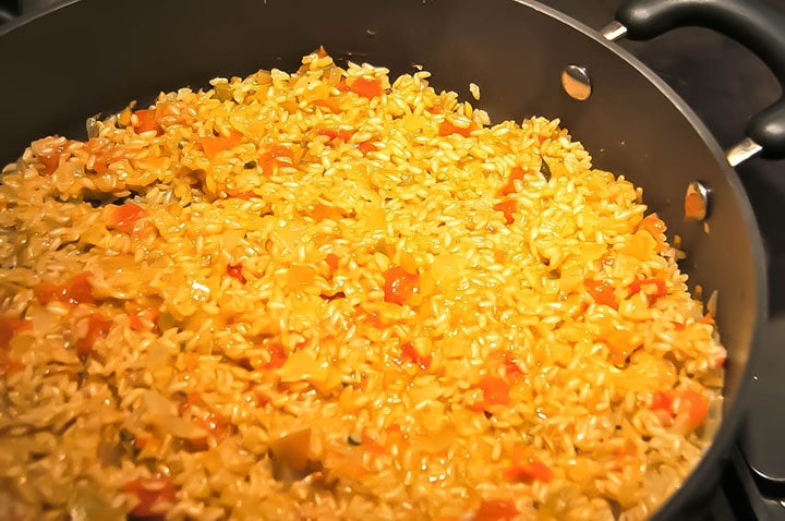 A pan with the cooked rice ready for adding the roasted vegetables